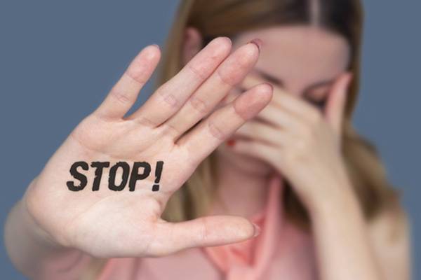 Quelle: Visual Force – istockphoto.com, istockphoto.com, Visual Force Frau streckt Arm aus, auf Handfläche steht "STOP!"